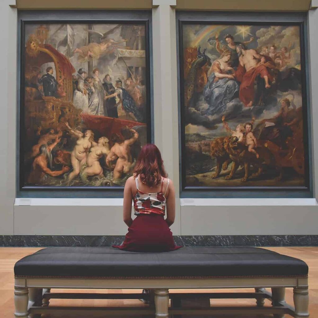 a woman looking at art in a museum