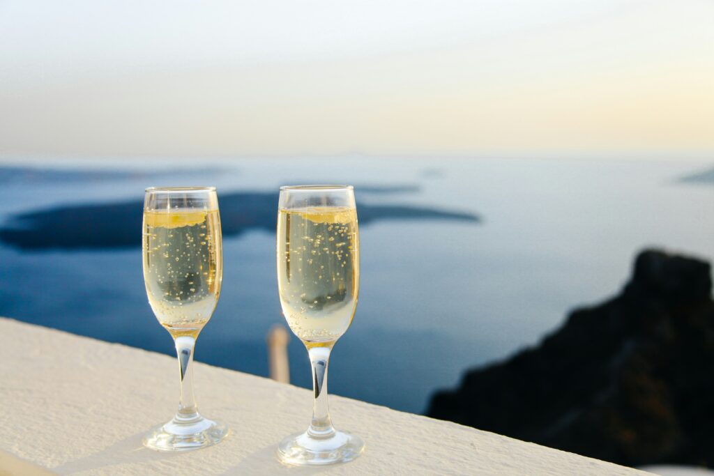 A photo of two champagne glasses and the ocean view