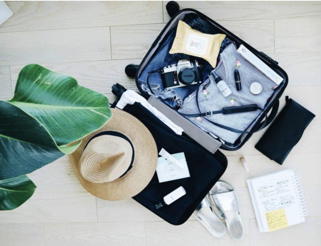 A photo of a suitcase and tourist items